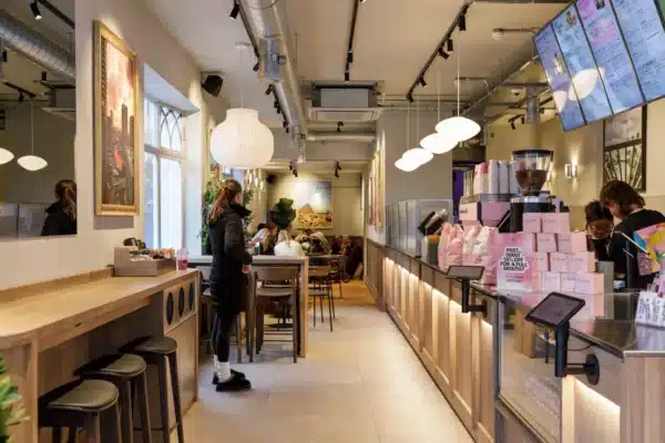 Joe & The Juice Windsor interior with service counter, seating and exposed ceiling services