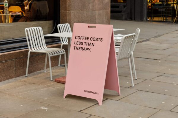 Pink Joe & The Juice pavement sign and outdoor cafe seating on High Holborn.