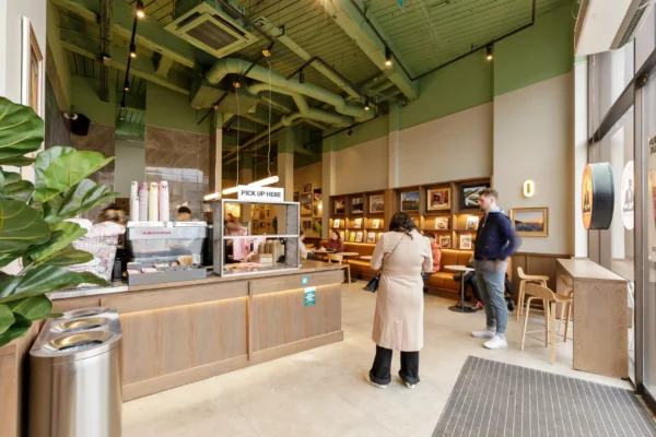View from the entrance at Joe & The Juice Wimbledon showing the servery, pick-up station and seating beyond