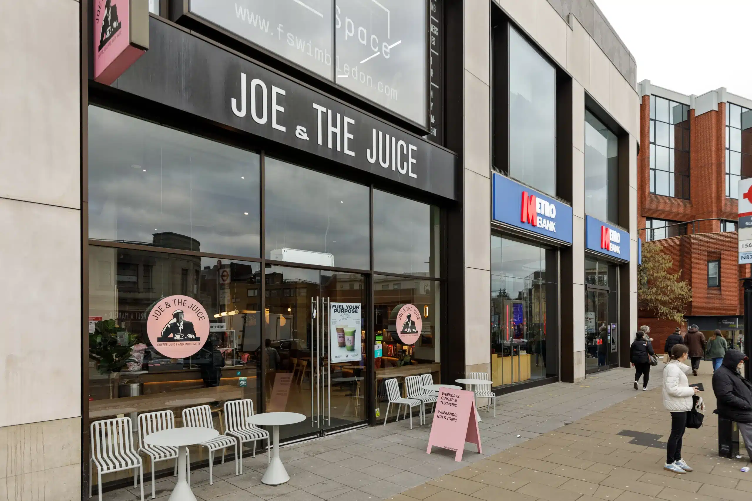 Close view of the Joe & The Juice Wimbledon fascia sign and full-height shopfront glazing with window graphics